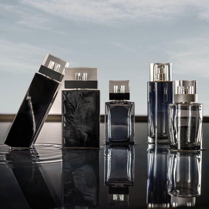 Premium Stoelzle perfume flacons on a reflective surface